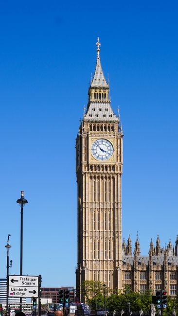 A tall clock tower, commonly known as Big Ben, located in Westminster, London, with intricate Gothic detailing on its stone facade and a large clock face displaying the time as approximately 11:15. Th